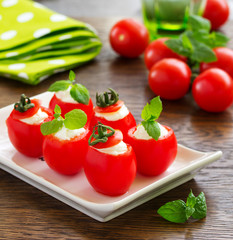 Cherry tomatoes stuffed with yogurt with mint.
