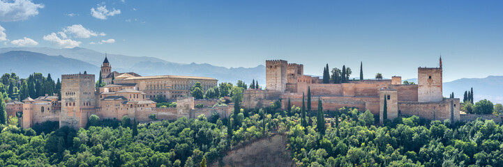 Alhambra in Granada, Andalusia. View of the world famous Alhambra with its Arab palaces and walls in southern Spain. - obrazy, fototapety, plakaty