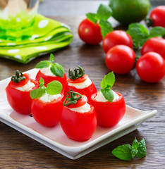 Cherry tomatoes stuffed with yogurt with mint.