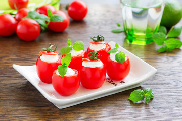 Cherry tomatoes stuffed with yogurt with mint.