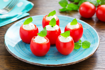 Cherry tomatoes stuffed with yogurt with mint.