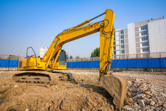 yellow backhoe loader on construction site and work