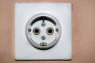 Three white European 220V power socket on green wall in Novi Sad, Serbia