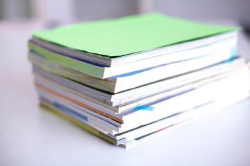 close up of stack of papers on white background