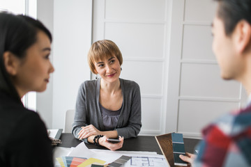 An interior designer consults with clients