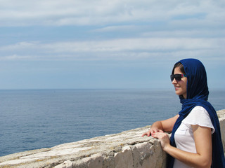 tourist arabic woman sightseeing at Dubrovnik ancient wall in Croatia