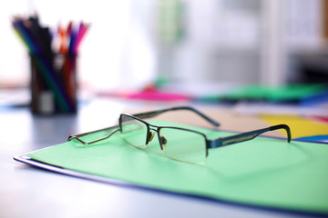 Office workplace with laptop and glasses on wood table