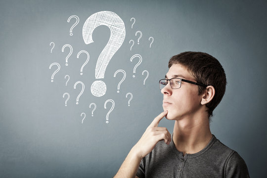 handsome minded teen trying to find way to solve problem, with many question marks