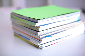 close up of stack of papers on white background