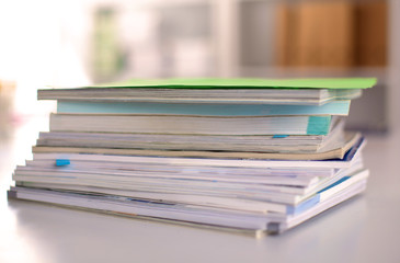 close up of stack of papers on white background