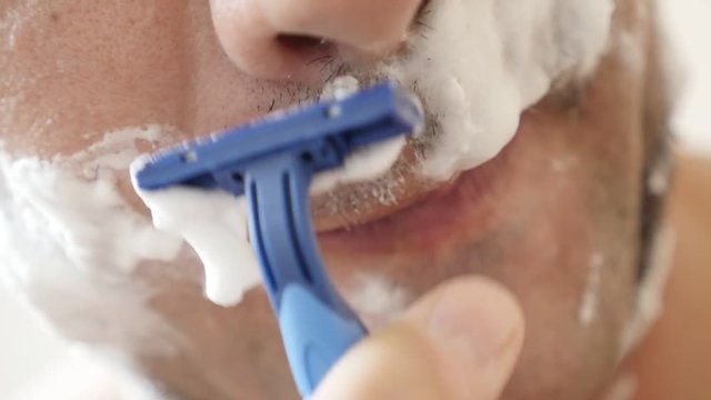 Male facial hair shaving under nose slow motion 1080p FullHD footage - Caucasian man with disposable razor shaves beard slow-mo 1920X1080 HD video.mov
