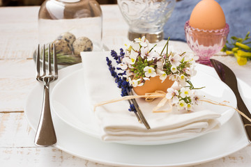 Easter table setting, white plates, napkin, flowers in eggshell, lavender, quail eggs, minimalistic, outdoors, kinfolk