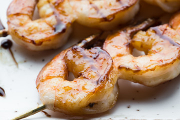 tasty spiced shrimp skewers on a barbecue