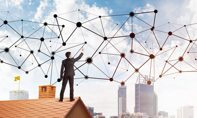 Businessman on house roof presenting networking and connection concept. Mixed media