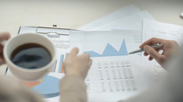 Business adviser analyzing financial figures denoting the progress in the work of the company