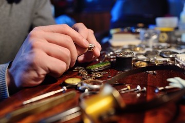 clockwork close up in the hands of a watchmaker