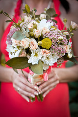 Wedding bouquet in hands of bride.