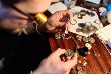 clockwork close up in the hands of a watchmaker
