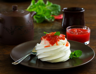 Dessert of meringue with rhubarb and mint sauce.