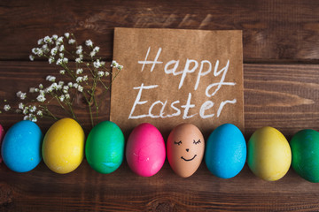 Colorful Easter eggs  on rustic wooden  background . Easter greeting card