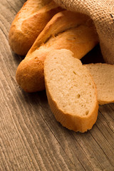 French baguette sliced on the wooden desk