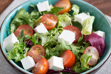 Salad with cherry tomatoes, Radicchio lettuce, frize, arugula and feta