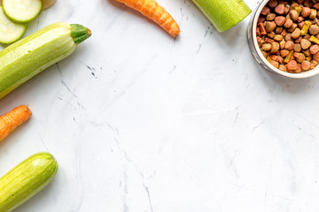 Carrot, zucchini and dry food set for pets top view mockup