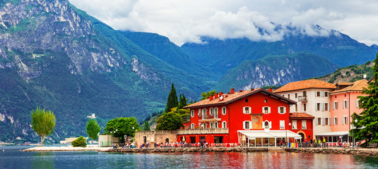Fototapeta na wymiar Alpine scenery - beautiful lake Lago di Garda and village Torbole. Italy