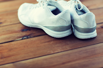 Fototapeta na wymiar close up of sneakers on wooden floor
