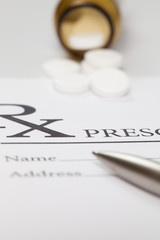 Fototapeta premium Some pills and a pen over medical prescription form