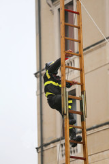 fireman climbs above the staircase