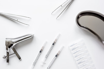 instruments of gynecologist on white background top view mock up