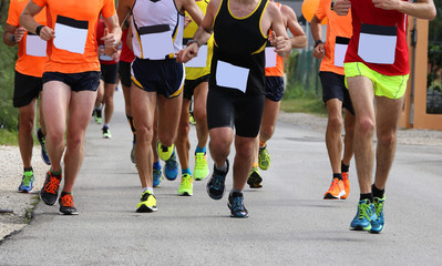 many athletes during the road race and white bib number