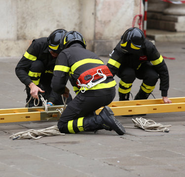 firemen during rescue operations with a wooden ladder