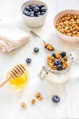 Fitness breakfast with granola and honey on white background