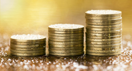 Golden coins closeup - website banner of money savings concept