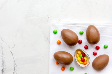 Easter chocolate eggs top view on stone background mock up