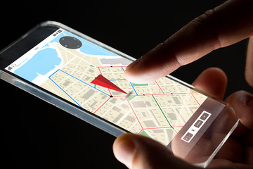 close up of hand with gps map on smartphone
