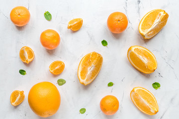 Making orange juice with mint on table background top view pattern