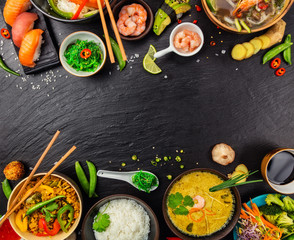Asian food served on black stone, top view, space for text