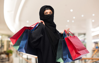 muslim woman in hijab with shopping bags