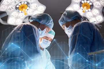 group of surgeons in operating room at hospital