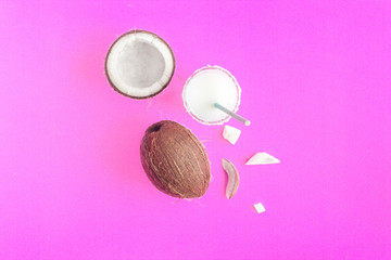 cocktail with coconut on purple background top view