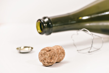 the end of the event (an empty champagne bottle and cork on white background)