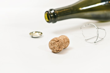 the end of the event (an empty champagne bottle and cork on white background)