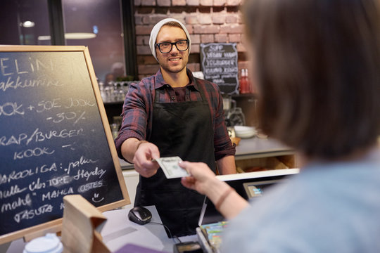 Happy Barman And Woman Paying Money At Cafe