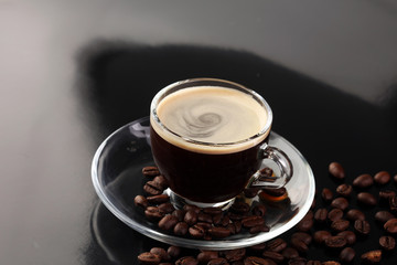 Coffee cup and coffee beans on table