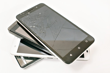 broken mobile phone with cracked screen over white background (ready to repair)