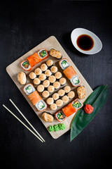 Sushi rolls set served on black background. Flat lay. Top view