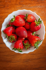 Bowl of red fresh strawberries on the table.
